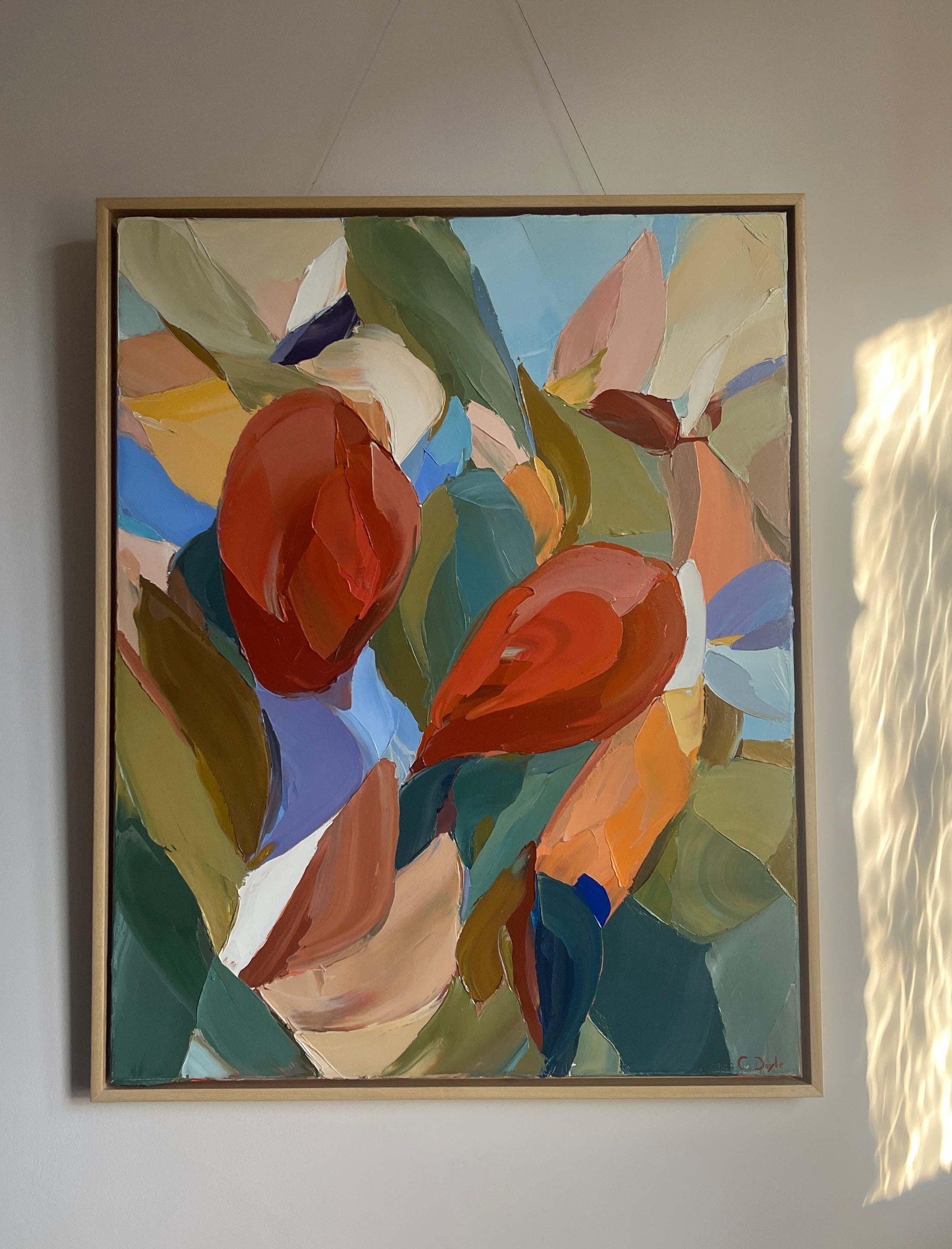 Abstract painting with colorful shapes on a white wall