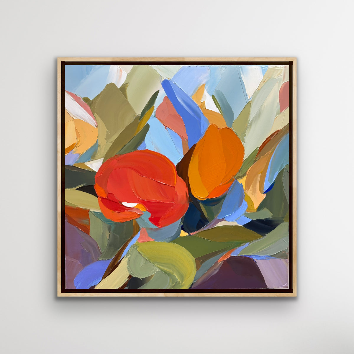 Abstract art oil painting by Connor J Doyle with colorful flowers in a gold frame on a light gray background. Executed with a palette knife.