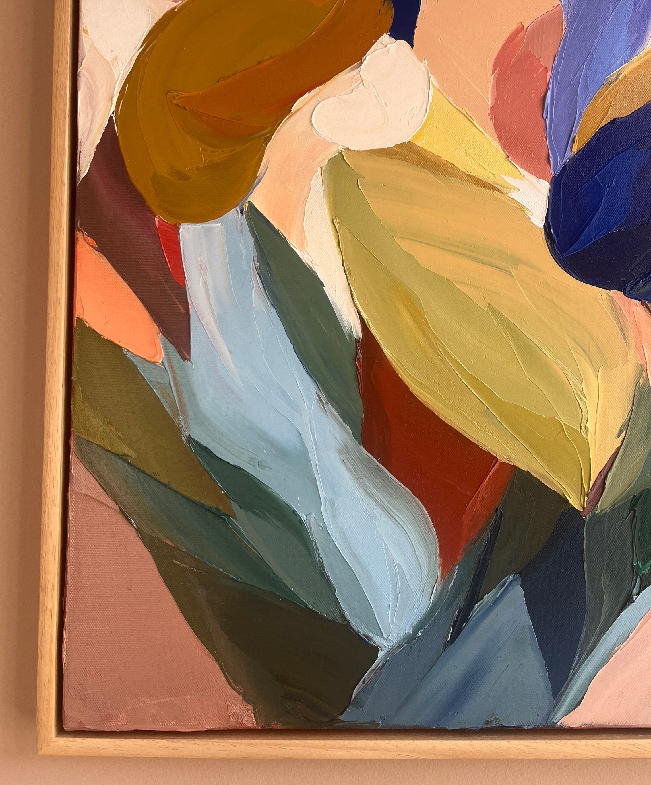 Abstract painting with colorful shapes on a beige wall