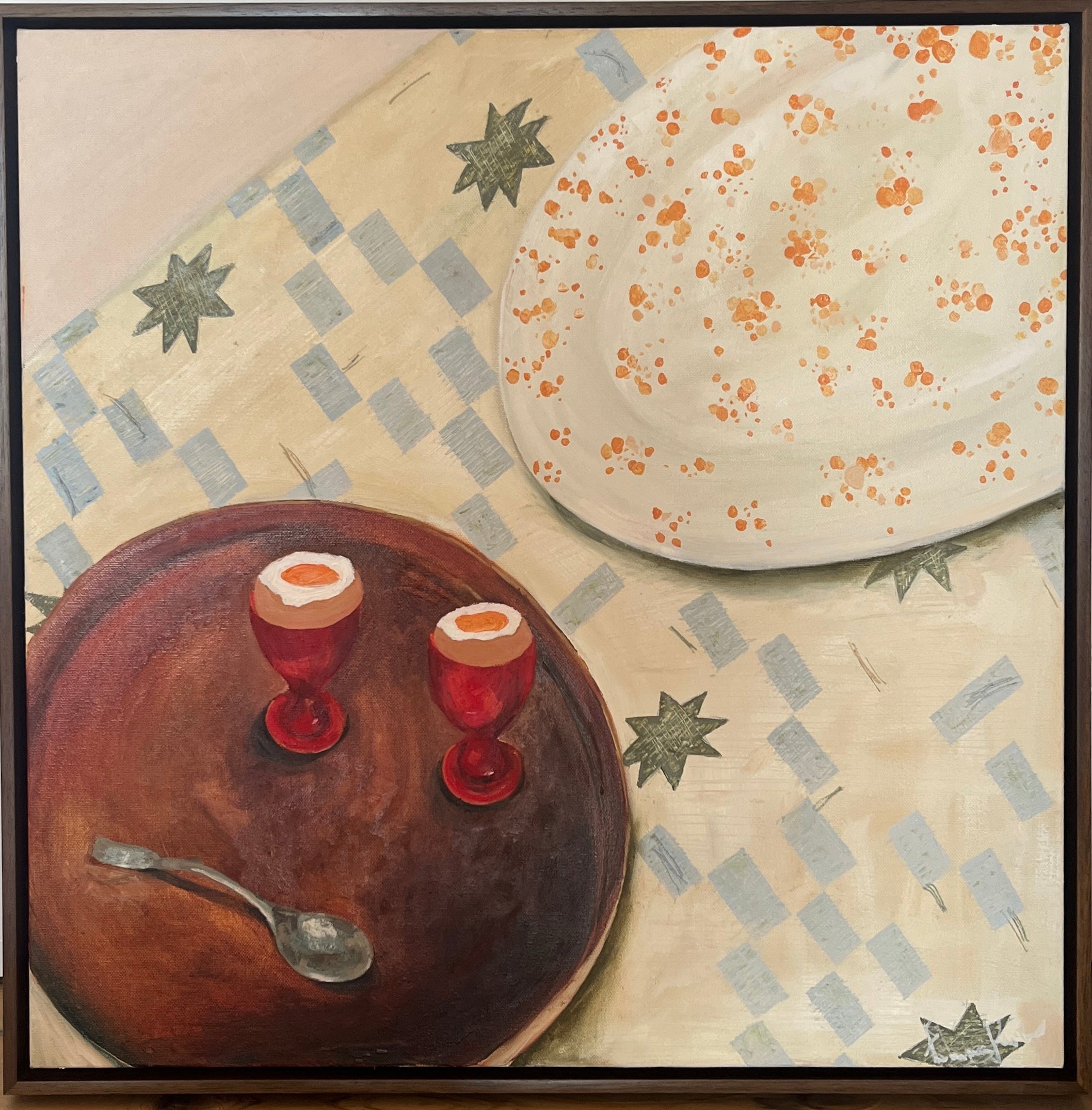 Picture of two boiled eggs on a tray say on a pattered blanket