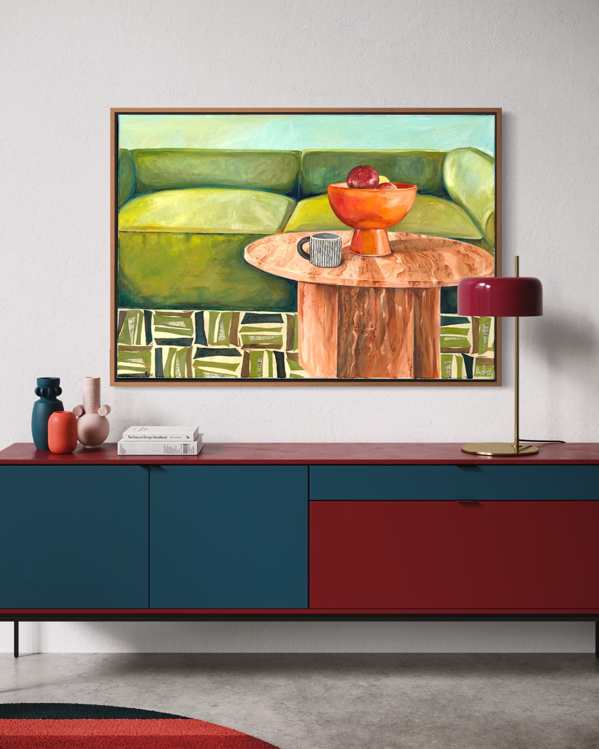 Modern living room with a colorful abstract painting above a red and blue cabinet.