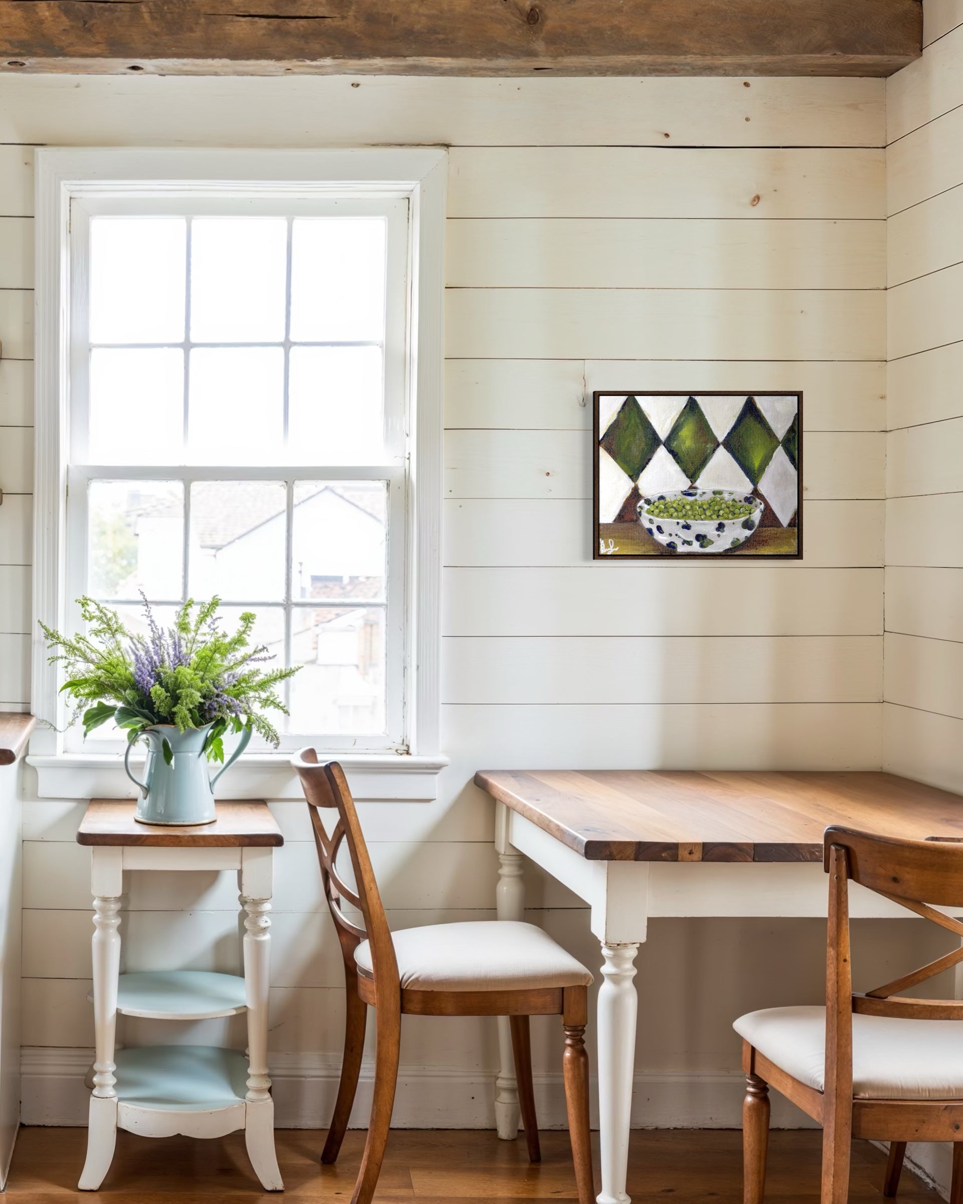 Dining area with wooden table and chairs, white walls, and a window.