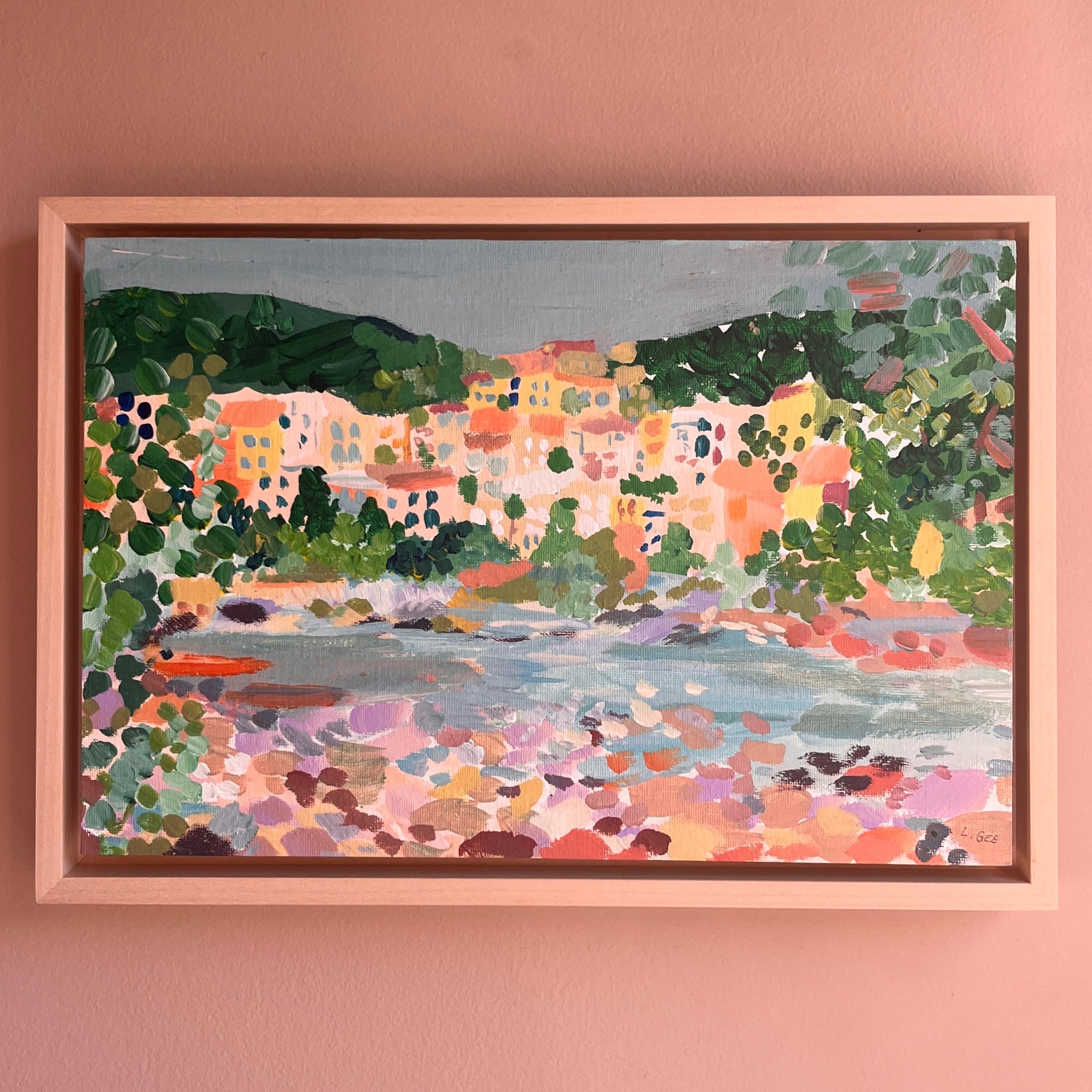 Holiday scene picture with a light frame on a peach wall.