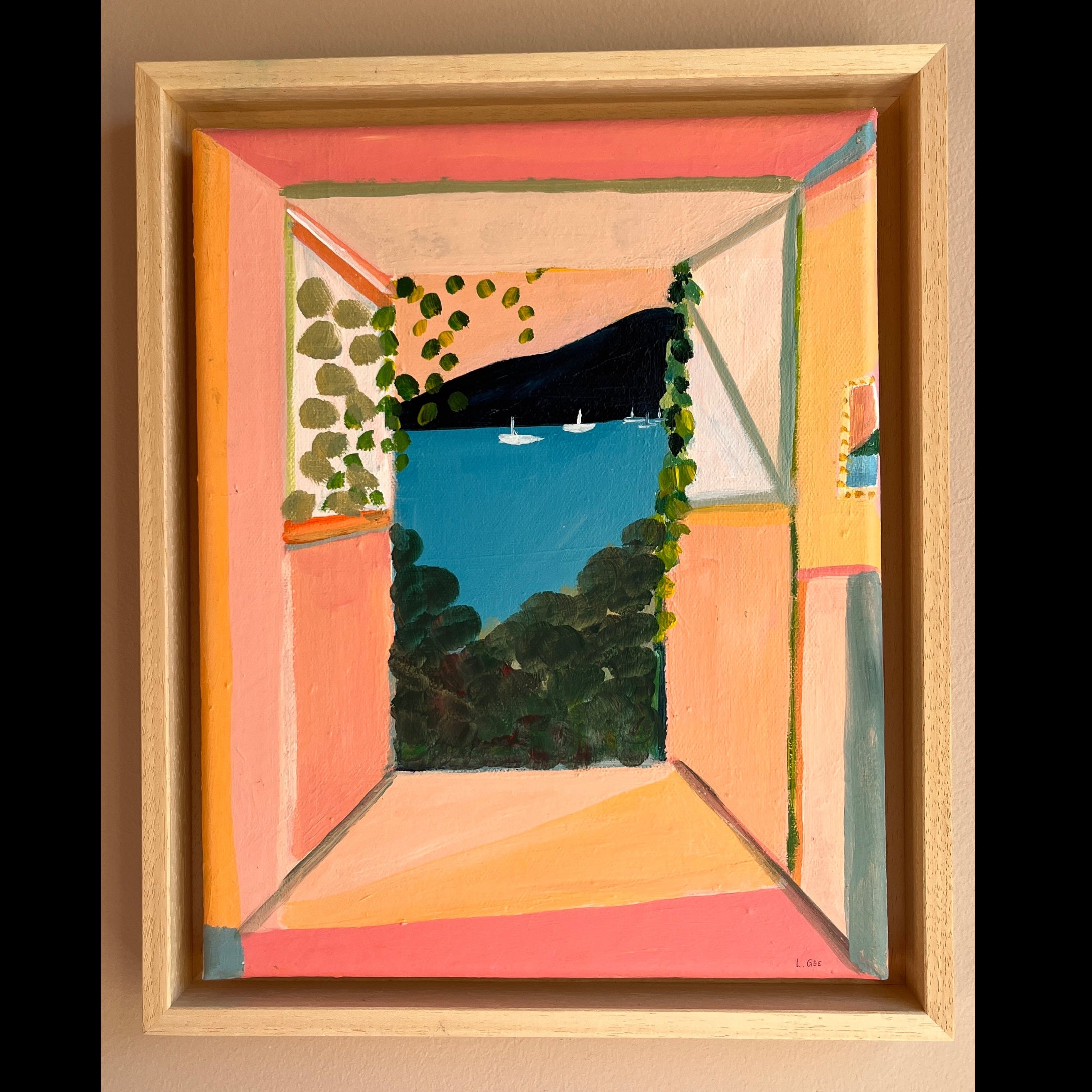 Framed abstract painting with geometric shapes and colors on a beige wall.