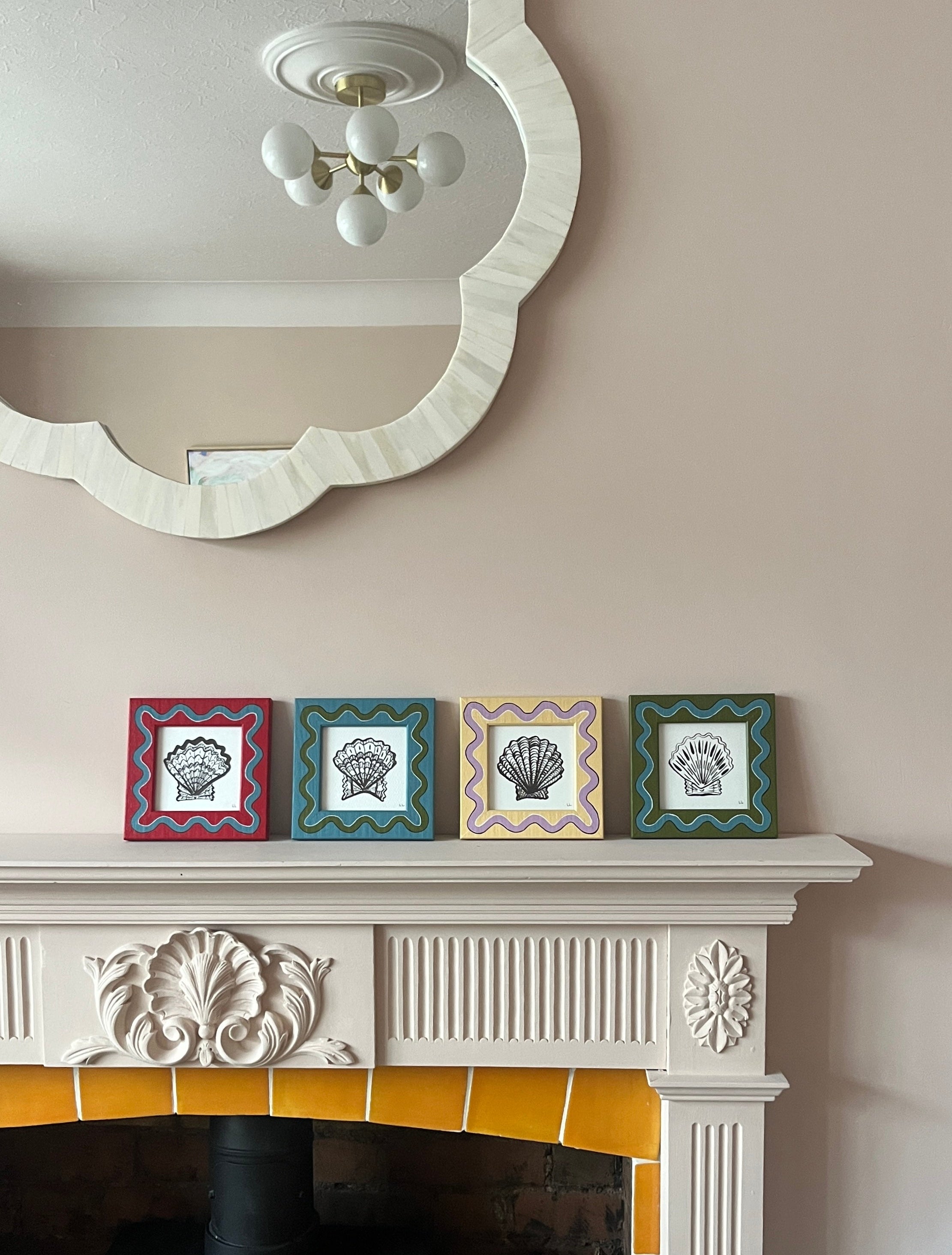 Fireplace with decorative tiles and a mirror above it on a beige wall.