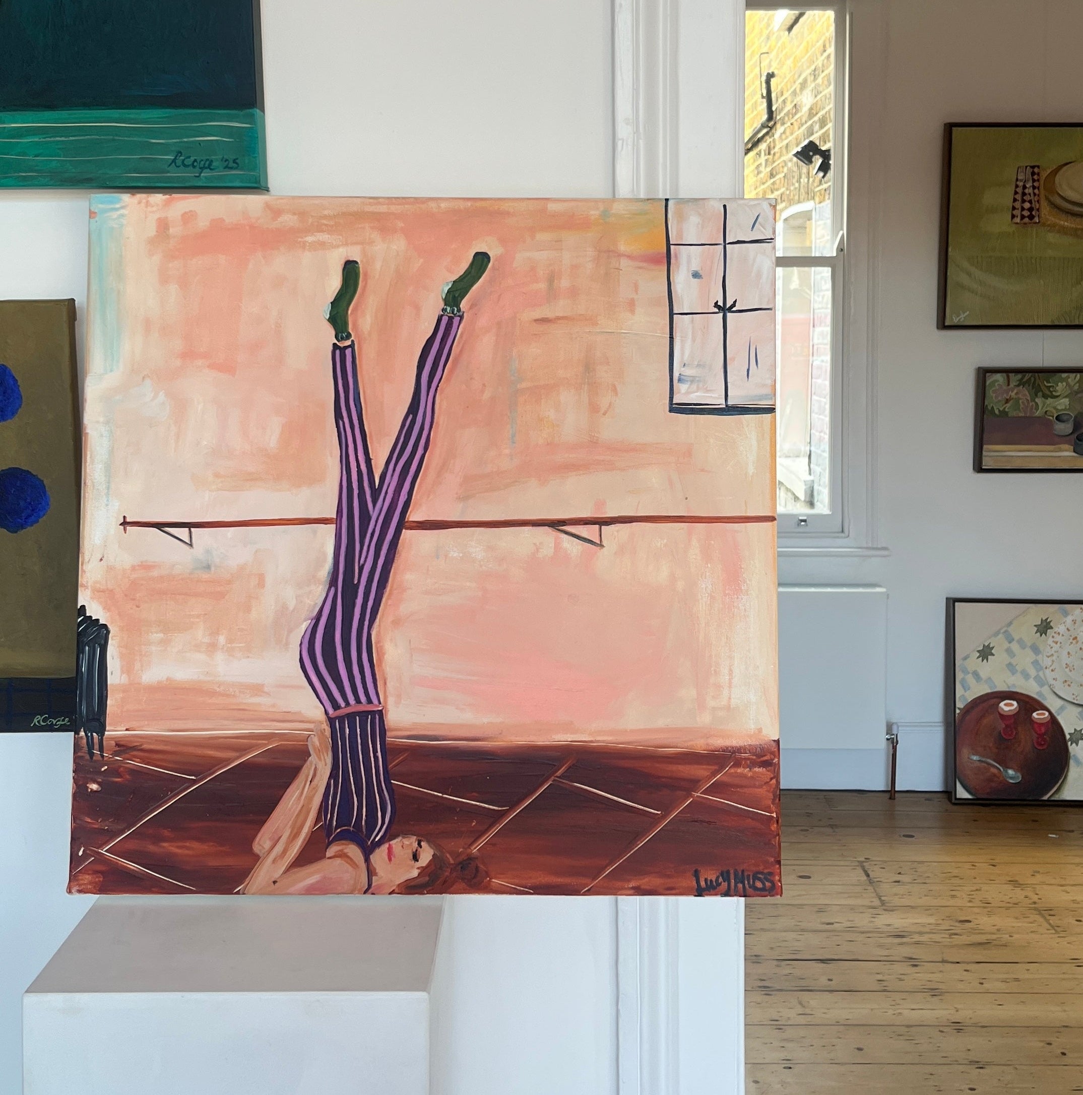 Image of painting in a gallery showing ballerina with her legs up on a bar.