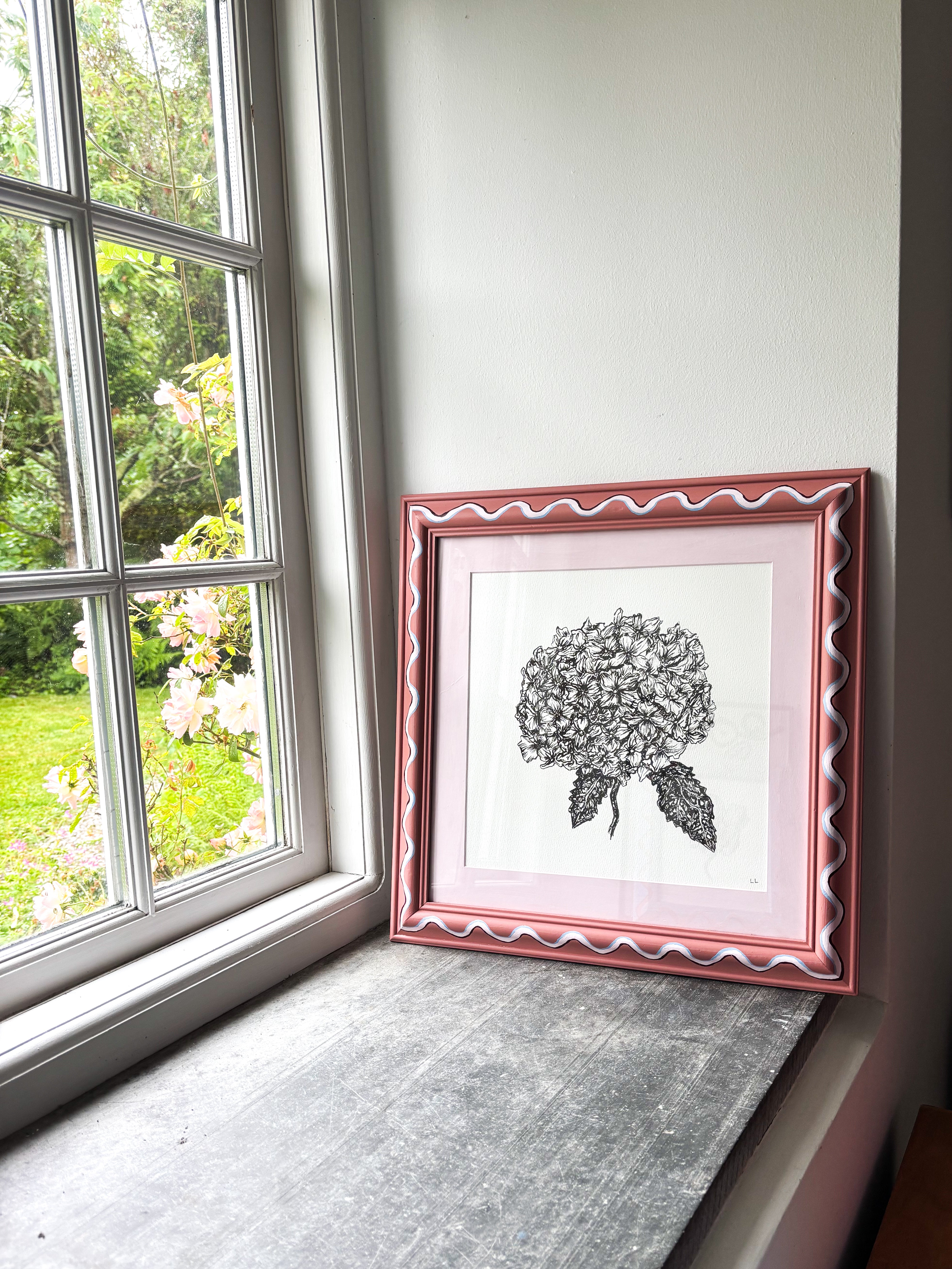 Hand painted frame sat on window ledge with botanical pen and ink drawing.
