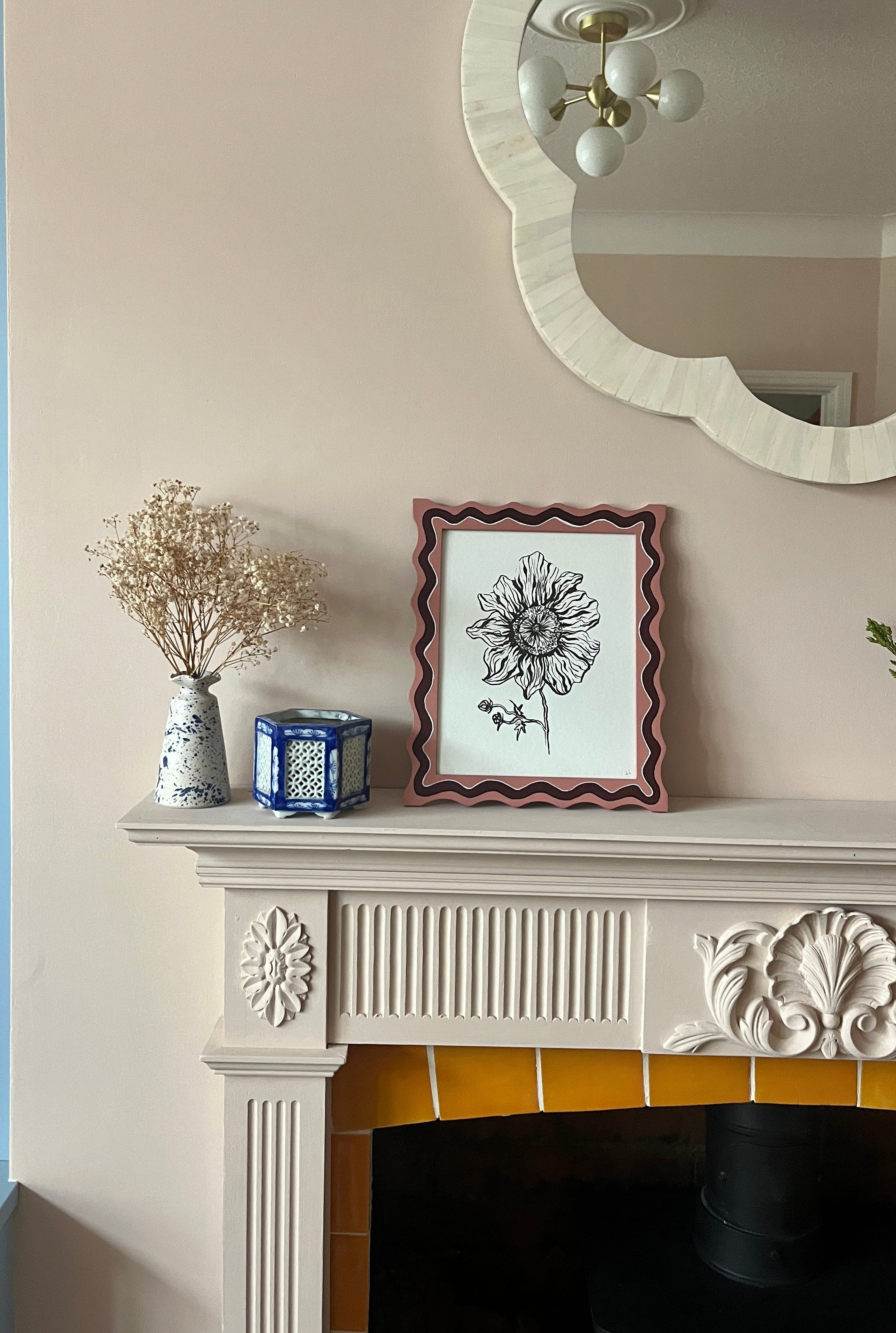 Decorative items on a fireplace mantel with a mirror above.