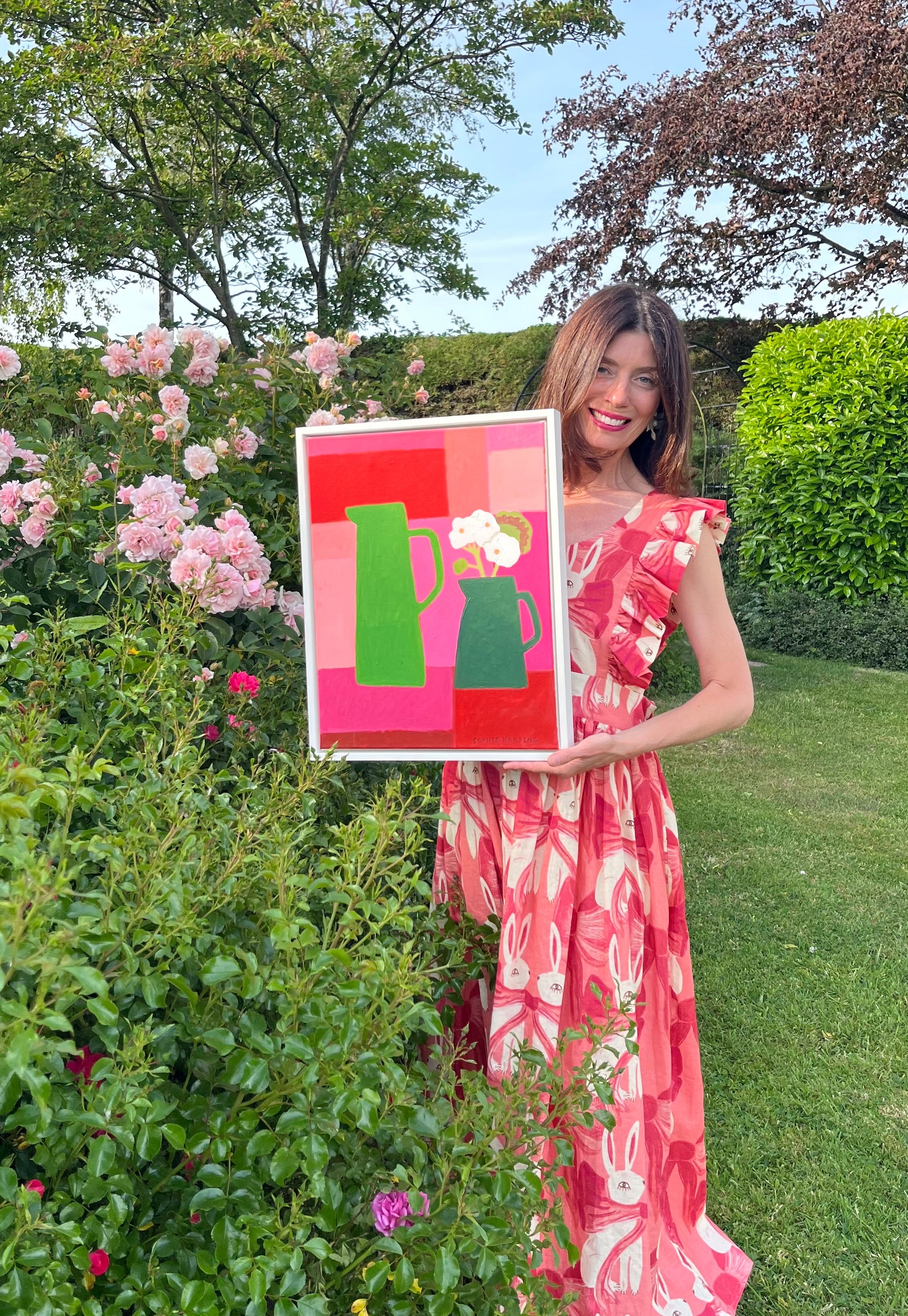 Picture of green jug being held by women in the garden