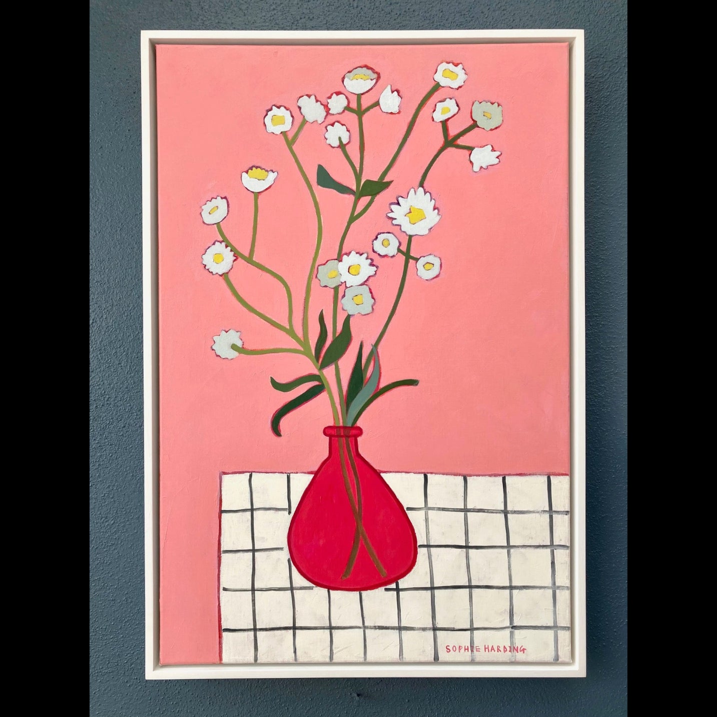Picture of white flowers with red vase with pink background