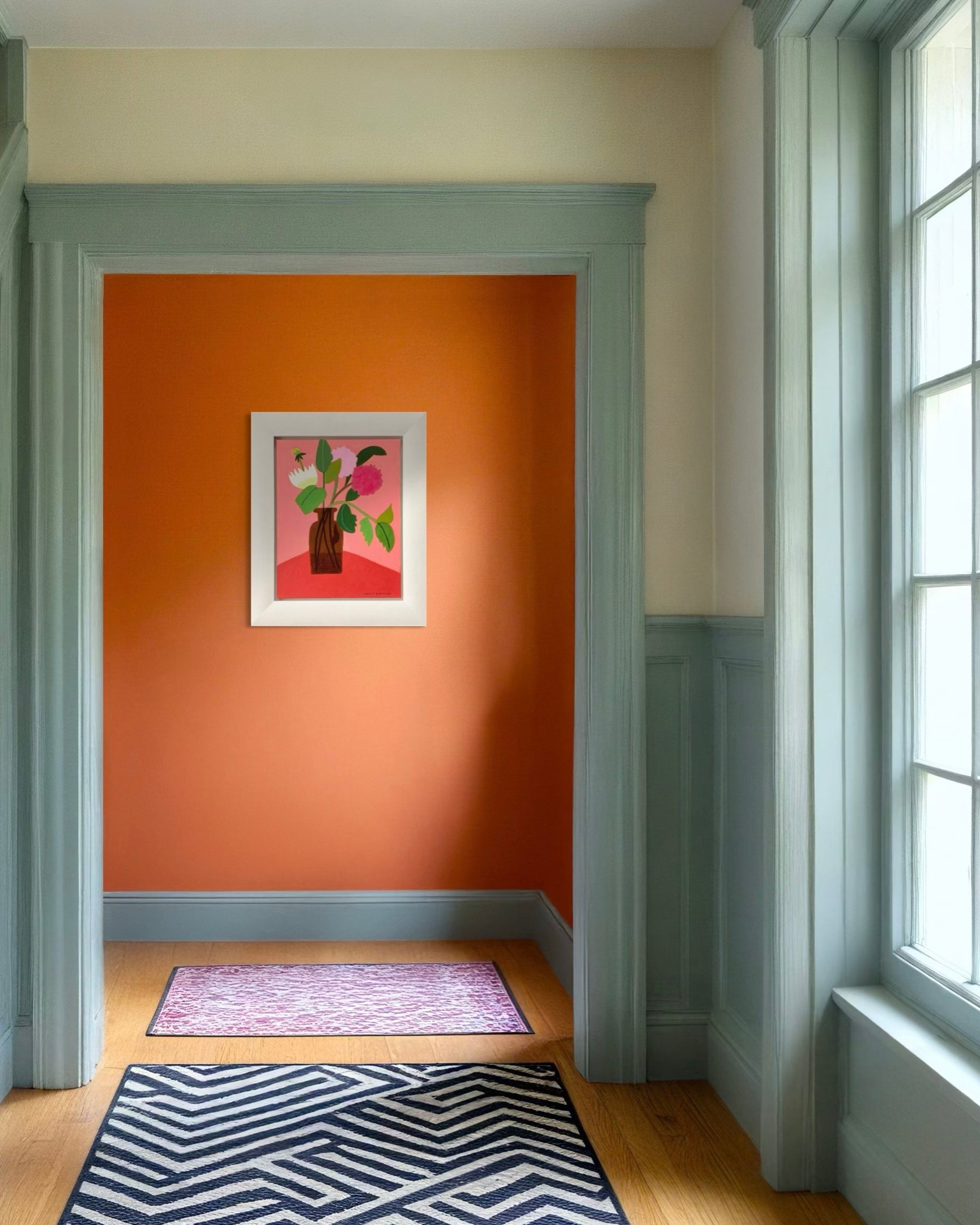 Colourful artwork sat on an orange wall