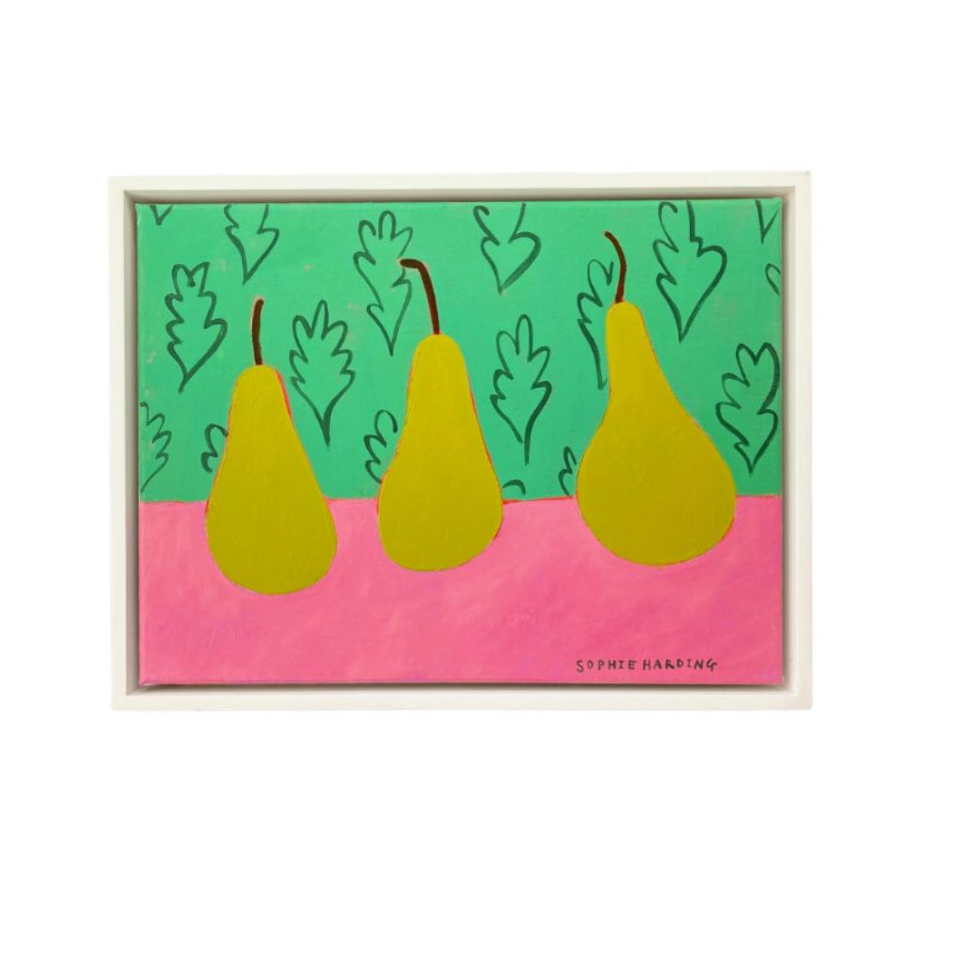 Framed artwork with three yellow pears on a pink and green background