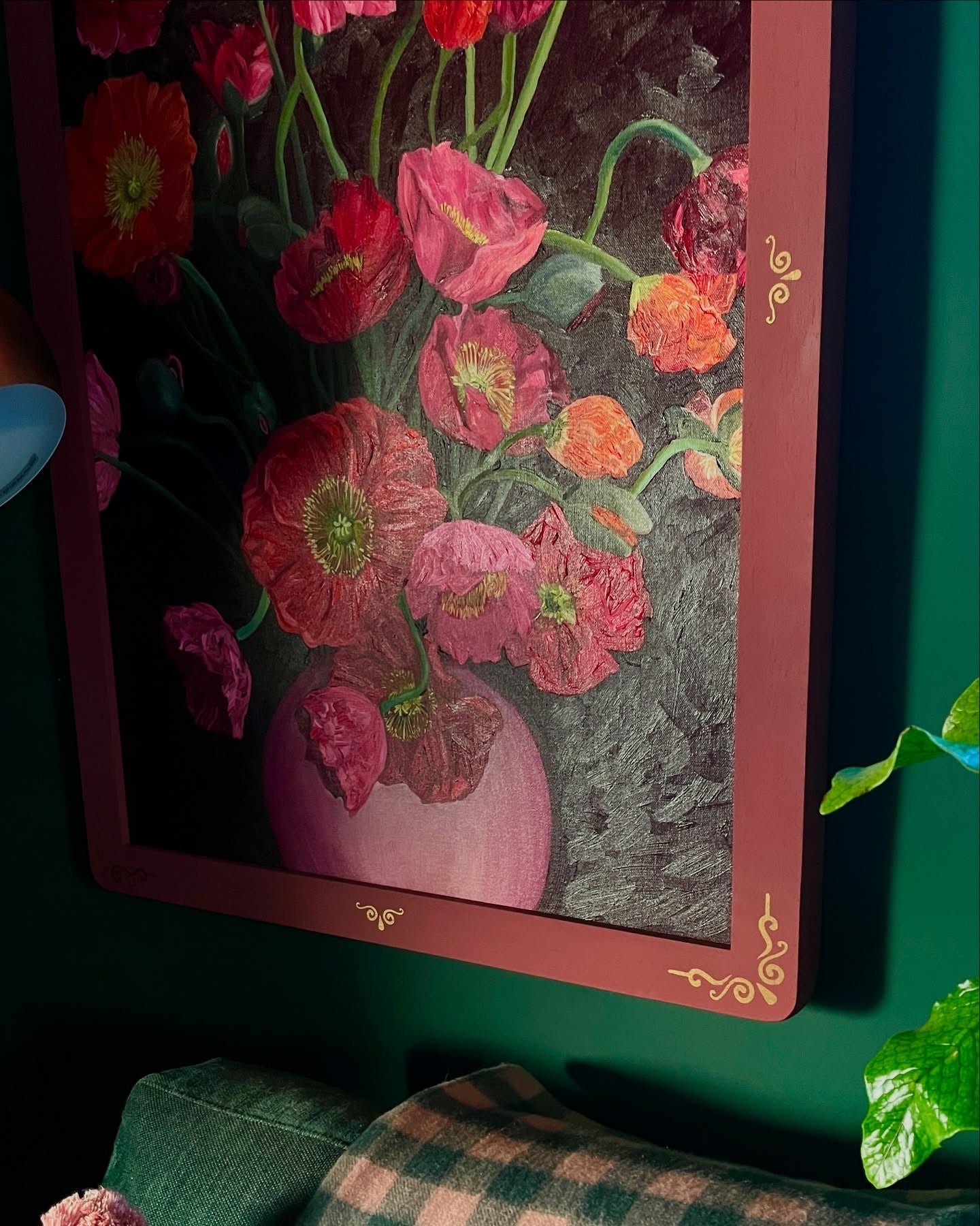 Framed artwork of pink flowers on a dark background