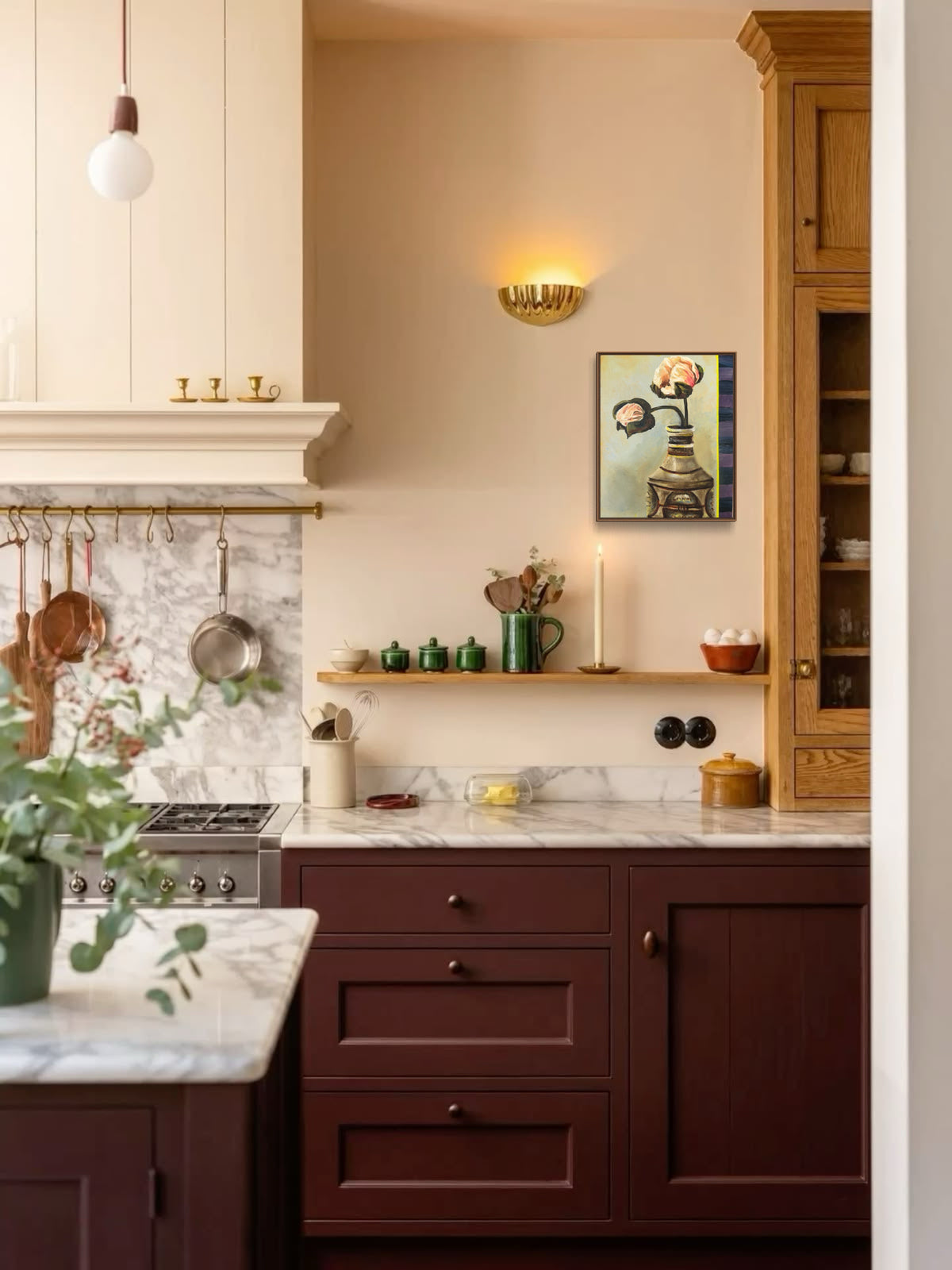 A warm, rustic kitchen interior featuring dark reddish-brown wooden cabinets, a white marble countertop, a cream-colored wall, and a small framed art print hanging on the wall.
