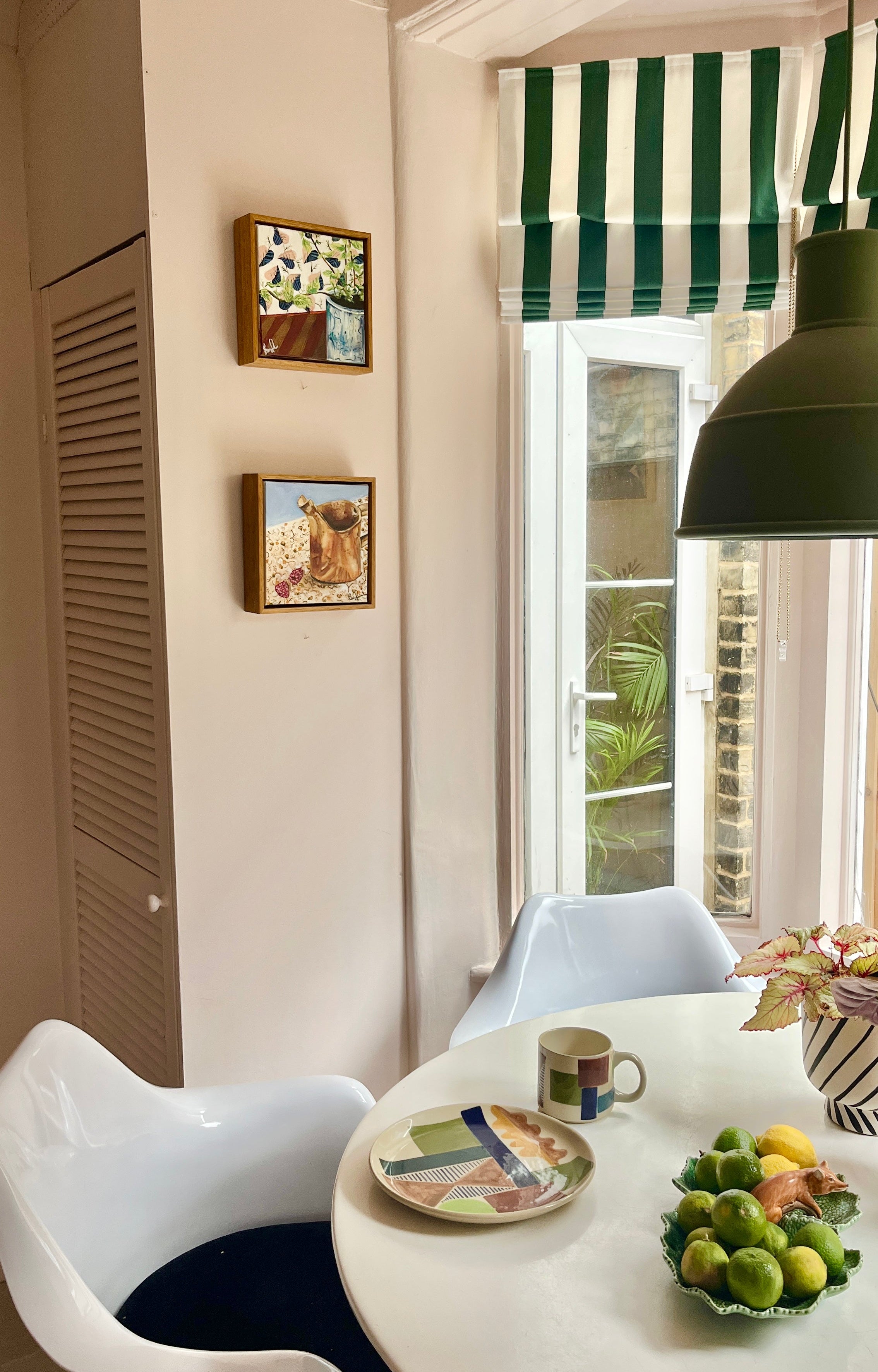 Dining area with a table, chairs, and decorative elements.