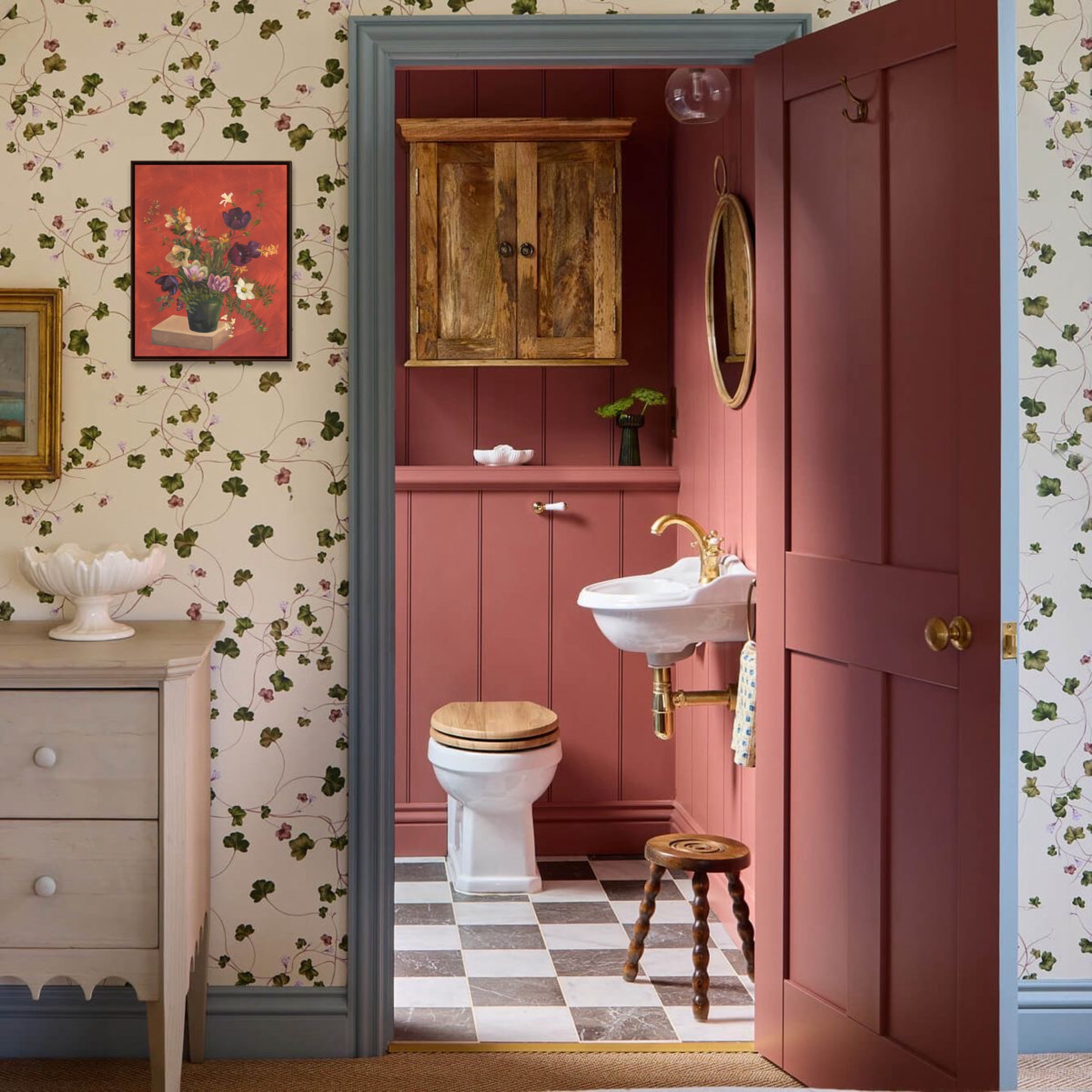 Bathroom with pink walls, wooden cabinet, and checkered floor.