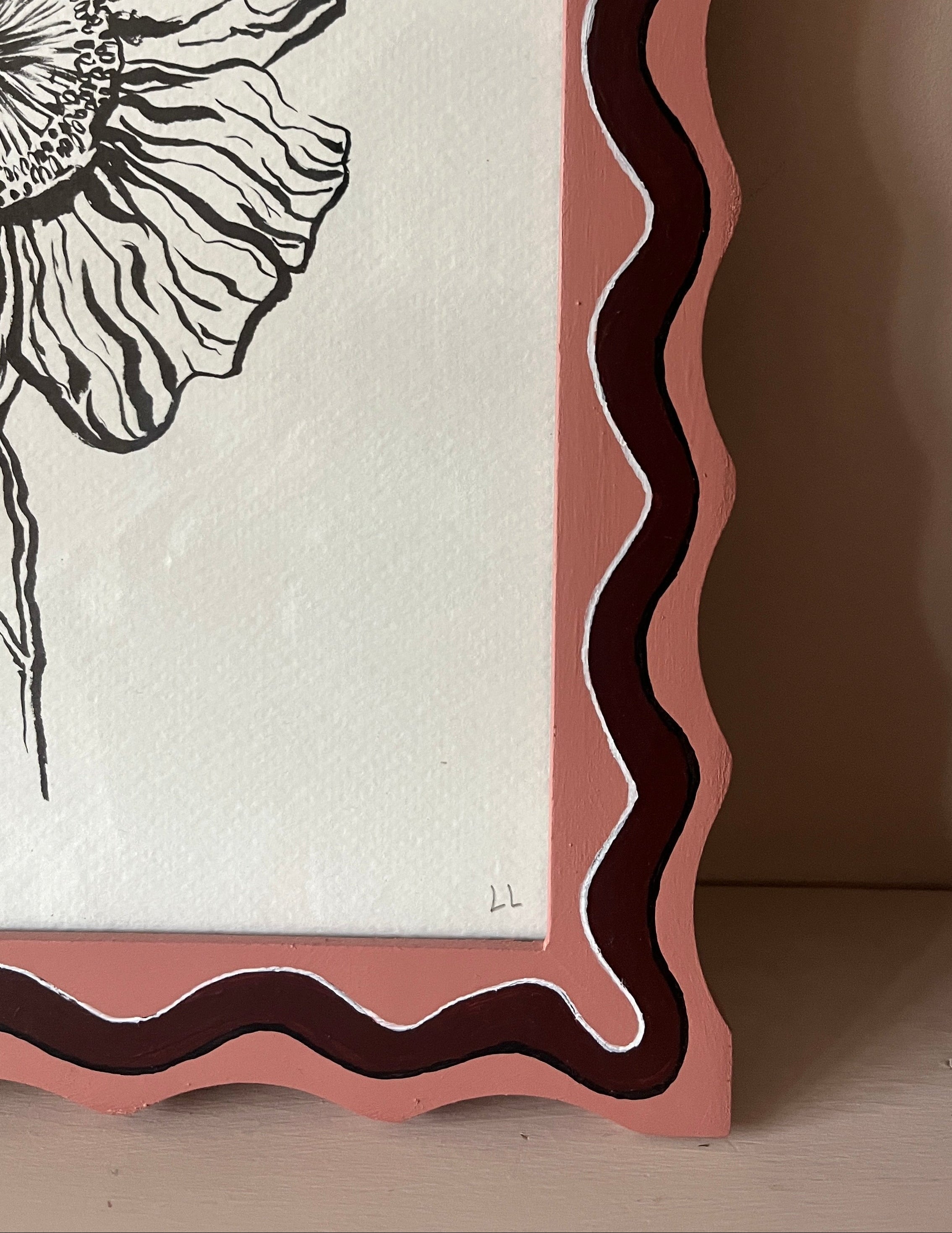 Framed artwork with a floral design on a white background