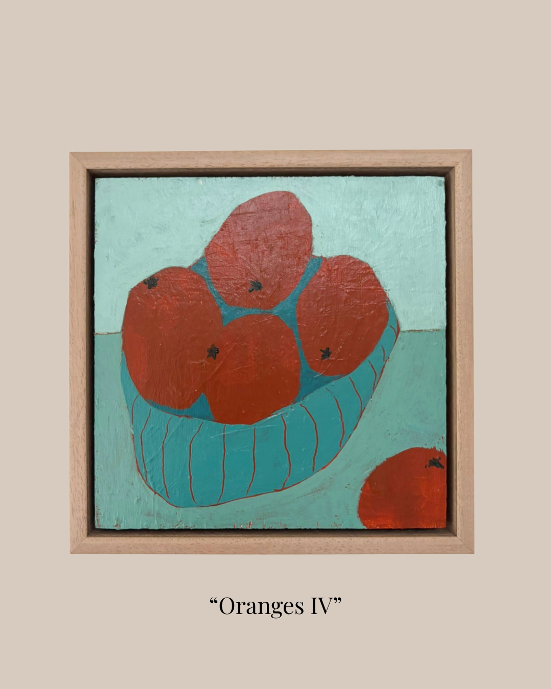 A framed painting titled "Oranges IV" showing four red-orange oranges in a teal bowl against a light teal background, set in a light wood frame on a beige background with the title below.