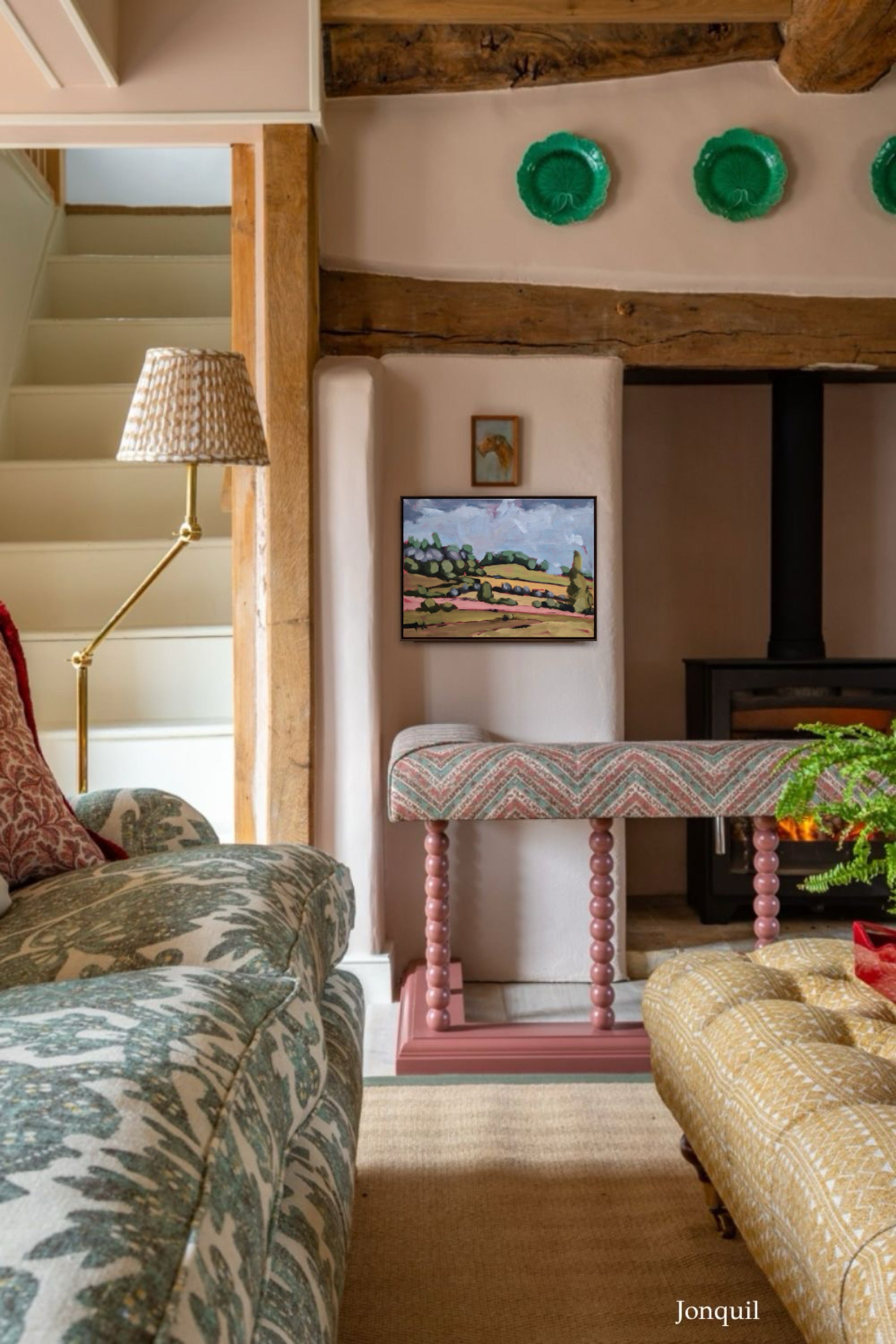 Living room with patterned sofa, decorative table, and wall art.