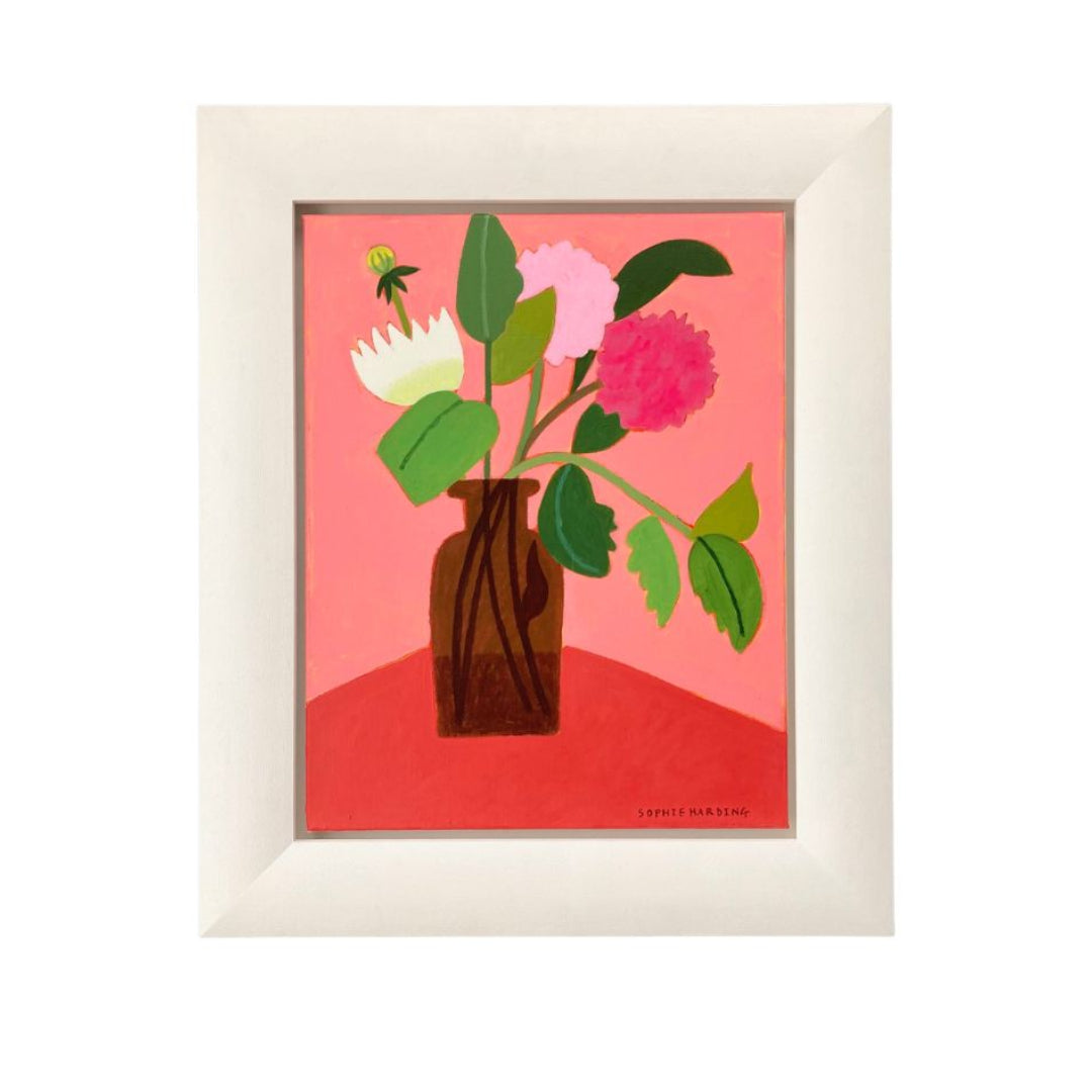 Framed artwork of flowers in a vase on a red background
