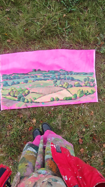 Women looking at lanscape art in a field