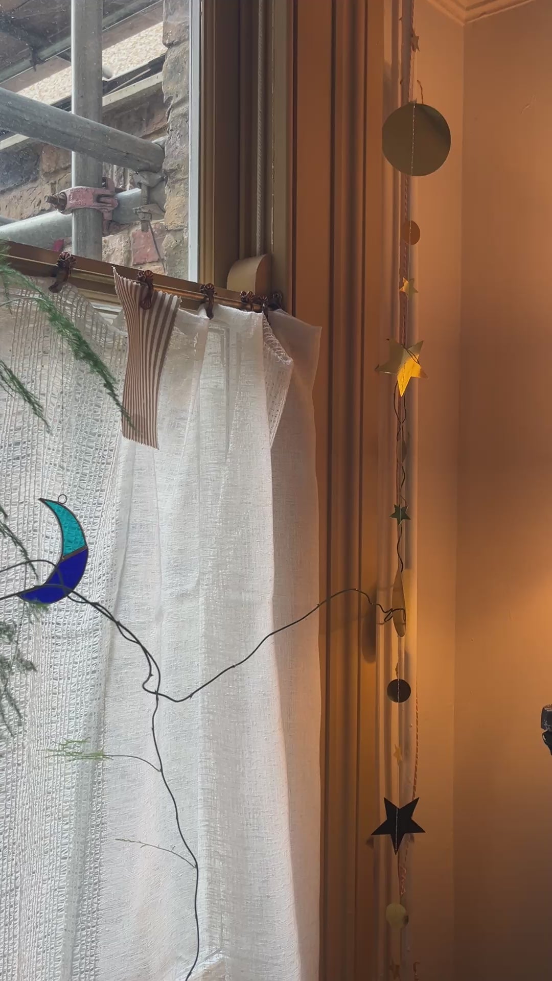 Moving image of Emma Gurner Original art work "garlic against the grain" in situ above a blak and white check cabinet. 