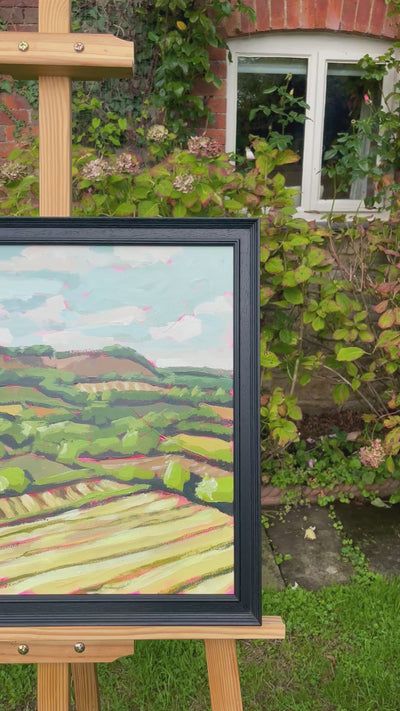 Moving image of a landscape painting on an easel