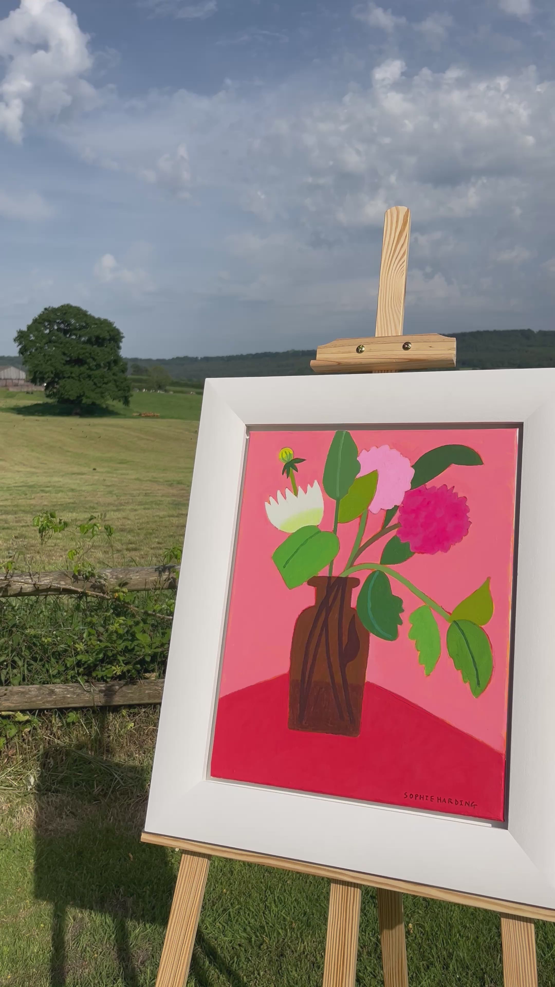 Block colour image of flowes with a field in the background 
